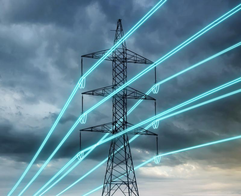 Electricity transmission line against dark blue sky